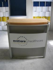 Custom eSmart Inline Convertible to (2) 10x10s. Features Vinyl Woven Panels, Lockable Storage, Puck Lighting, Monitor Mounts, and Modified ECO-31C Counter -- Image 2