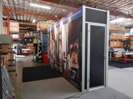 RENTAL: Storage Room (186" W x 39" D x 116" H) with SEG Tension Fabric Graphics, Locking Door, Large Monitor Mounts, and Halogen Arm Lights -- Image 1
