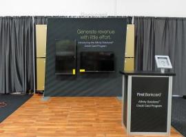 Custom SEGUE Exhibit with SEG Graphics, Monitor Mounts, iPad Stand, and MOD-1551 Counter with Storage