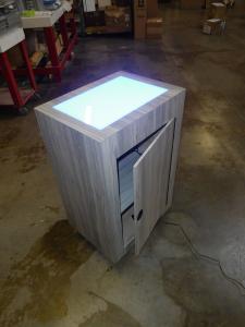 Custom MOD-1565 Product Pedestal with Acrylic Uplighting, LED Perimeter Light, and Locking Storage