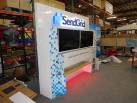 Custom Exhibit with (2) Monitor Mounts, Dimension Letters and Logo, LED Accent Lights, Storage, and Shelf