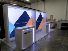 (2) VK-1340 Custom Inline Exhibits with SuperNova Backlit Fabric Graphics and (2) MOD-1563 Counters with Locking Storage